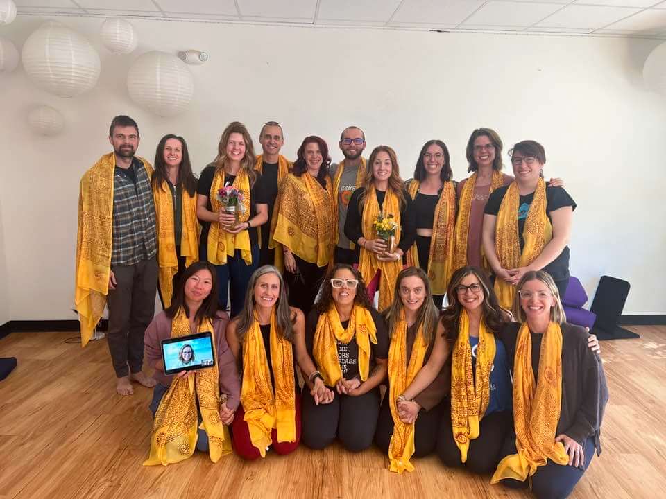 Image of 300 hour students wearing yellow sadhanas at the Pikes Peak studio