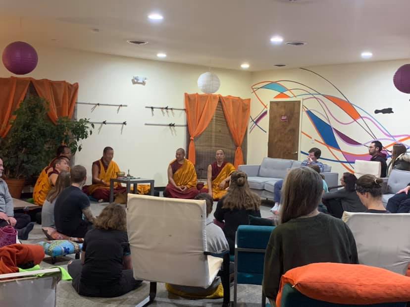 Monks talking to audience